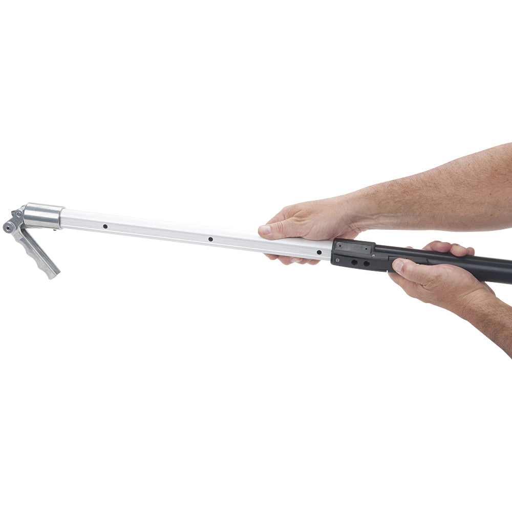 Hands extending a 41-inch- 63-inch Asgard Finishing Box Handle with black handle and grey stainless steel interior tube and brake handle