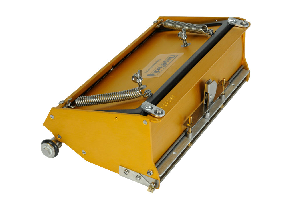 10-inch TapeTech EasyClean Finishing Box with gold aluminum body, brass blade holder, and crown control, quarter view